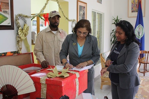 Amelia M. Poornananda J.P., Administrative Officer at the Office of the Governor General signing to recieve Petition Signatures being delivered by Oceanas' V.P Audrey Matura-Shepherd and COLA's President, Moses Sulph.